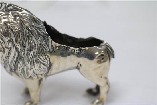 An Edwardian silver pincushion in the form of a standing lion (cushion and tail deficient),